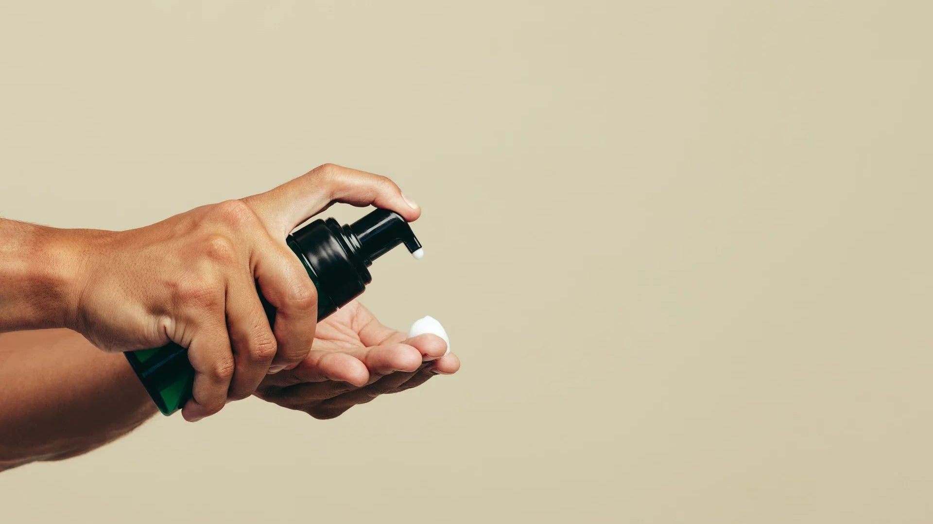 A man putting bleaching gel onto his finger to apply it