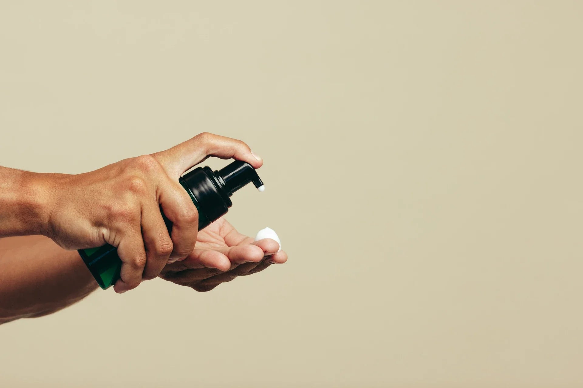 A man putting bleaching gel onto his finger to apply it